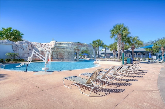 community pool featuring a patio and fence