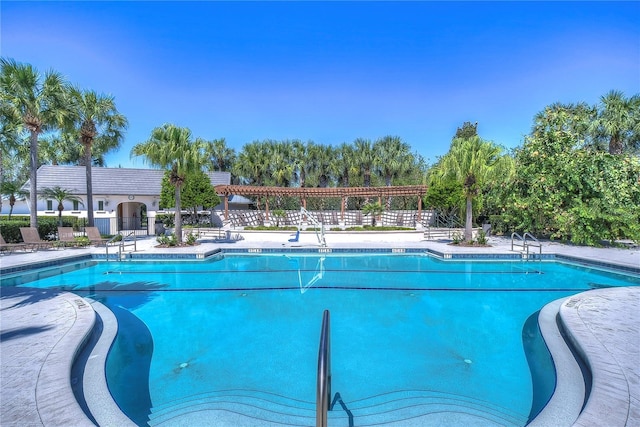 pool featuring a patio area and fence