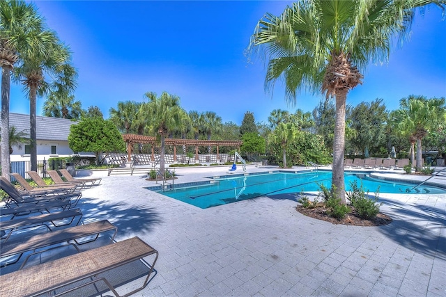 pool featuring a patio area, fence, and a pergola