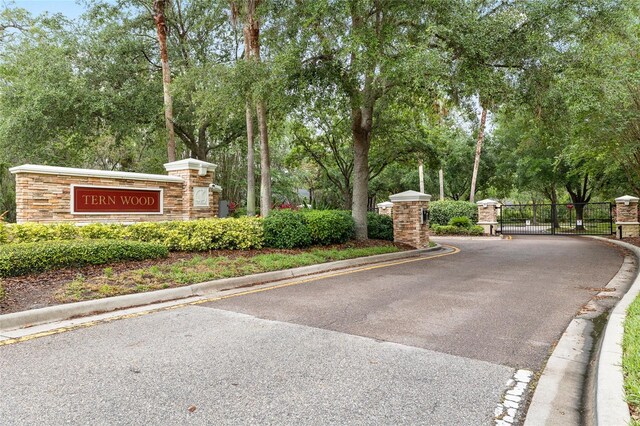 15912 Ternglade Dr, Lithia, FL 33547 - community / neighborhood sign with a gate and view of scattered trees