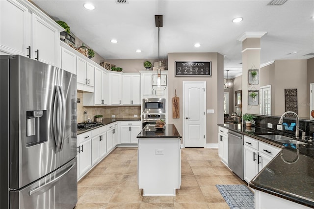 15912 Ternglade Dr, Lithia, FL 33547 - kitchen featuring stainless steel appliances, a center island, a sink, decorative backsplash, and white cabinetry