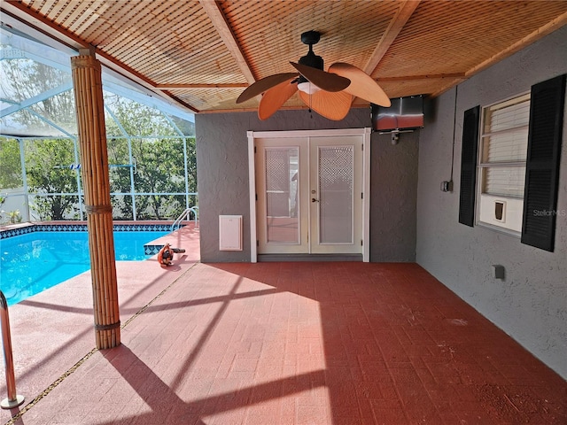 unfurnished sunroom featuring a ceiling fan, wood ceiling, and french doors