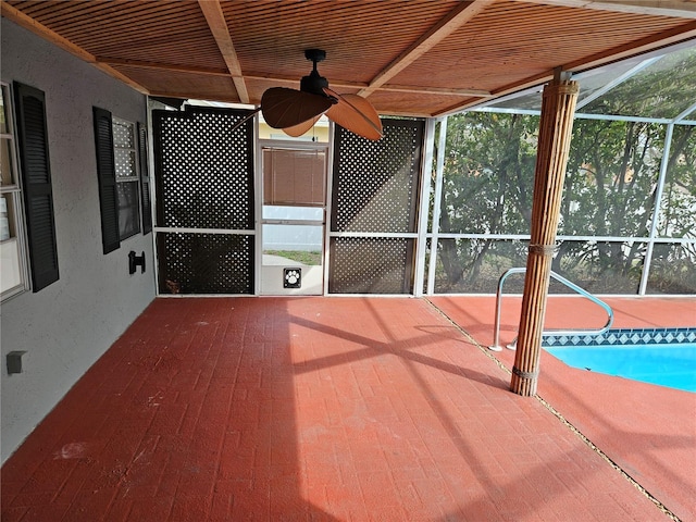 exterior space featuring ceiling fan, glass enclosure, and an outdoor pool