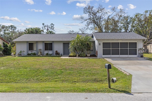 single story home with a garage, driveway, a front lawn, and stucco siding