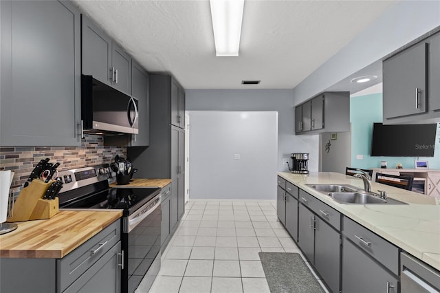 kitchen with electric range, black microwave, a sink, and gray cabinetry