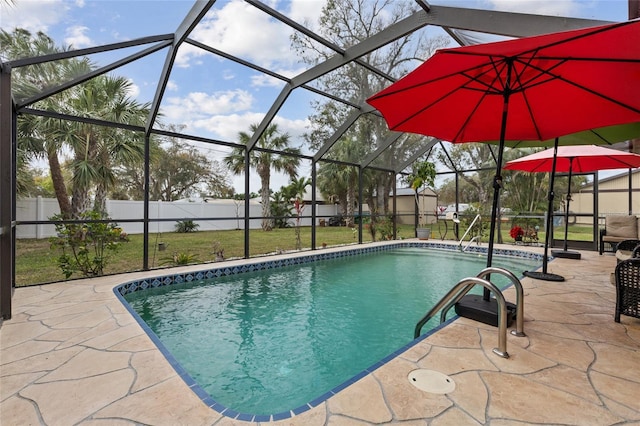 view of swimming pool featuring glass enclosure, a patio area, a fenced backyard, and a fenced in pool