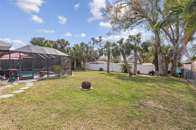 view of yard with a lanai, a fenced backyard, and a fenced in pool