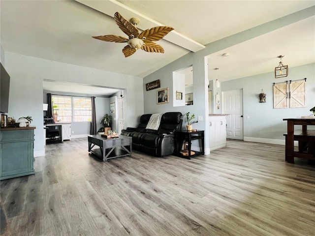 living room with vaulted ceiling, ceiling fan, baseboards, and wood finished floors