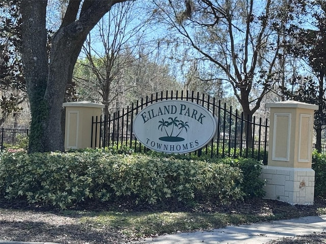 community sign featuring fence