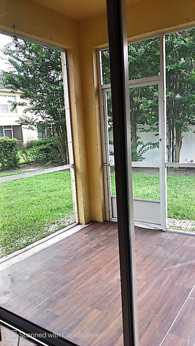 doorway to outside with a healthy amount of sunlight and wood finished floors