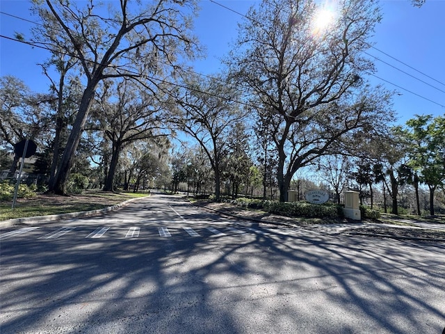 view of road with traffic signs and curbs