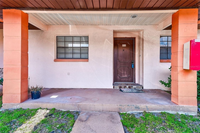 doorway to property with stucco siding