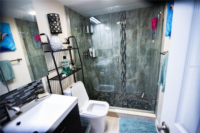 full bathroom with a shower stall, toilet, and vanity