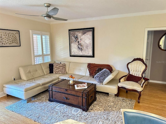 living area with crown molding and wood finished floors