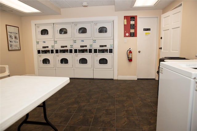 common laundry area with baseboards, independent washer and dryer, and stacked washing maching and dryer