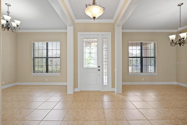 foyer featuring light tile patterned flooring, baseboards, an inviting chandelier, and ornamental molding