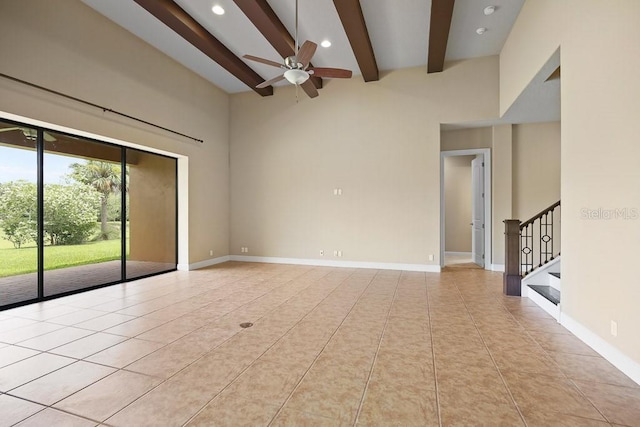 spare room featuring stairs, beam ceiling, baseboards, and ceiling fan