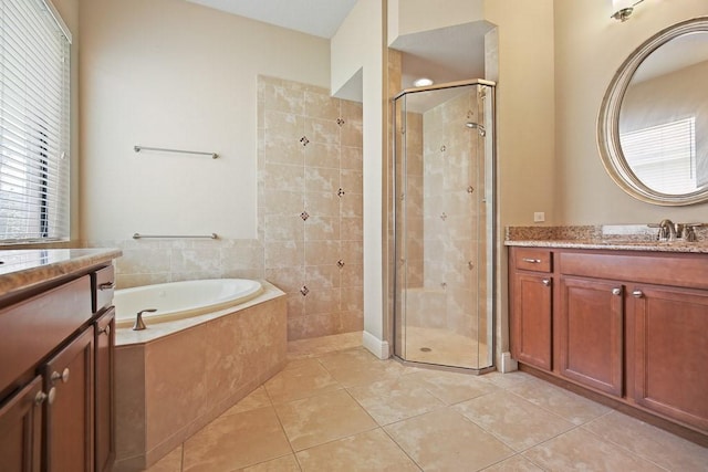 bathroom with tile patterned floors, a shower stall, vanity, and a bath