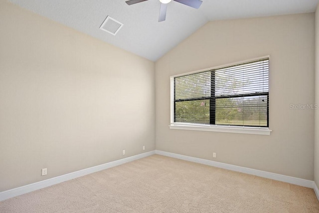 unfurnished room with baseboards, visible vents, lofted ceiling, ceiling fan, and light carpet