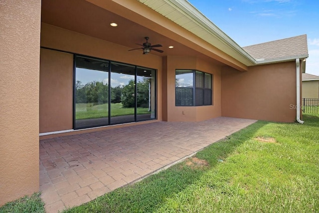 view of patio / terrace featuring ceiling fan and fence