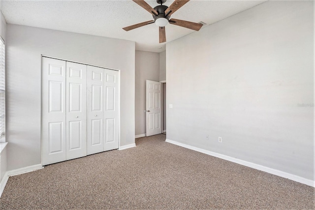 unfurnished bedroom with a closet, carpet flooring, ceiling fan, and baseboards