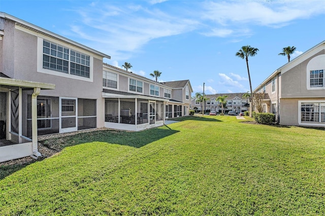 view of yard with a sunroom and a residential view