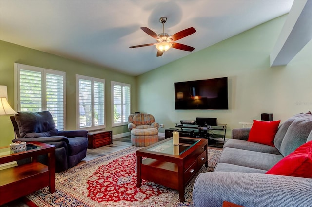 living room with lofted ceiling, baseboards, a ceiling fan, and wood finished floors