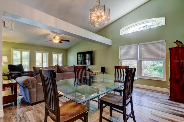 dining area featuring vaulted ceiling, light wood-type flooring, and a healthy amount of sunlight