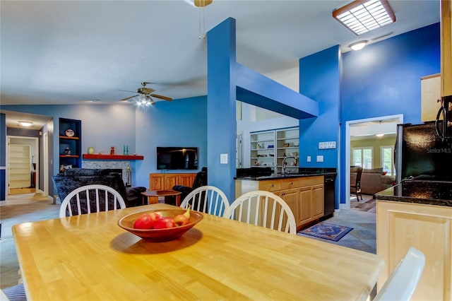 dining space featuring built in shelves, a fireplace, high vaulted ceiling, and a ceiling fan