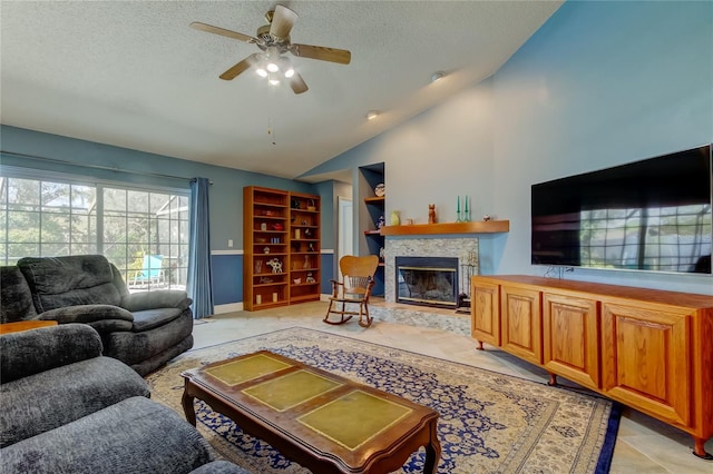 living area with lofted ceiling, a fireplace, a textured ceiling, and ceiling fan