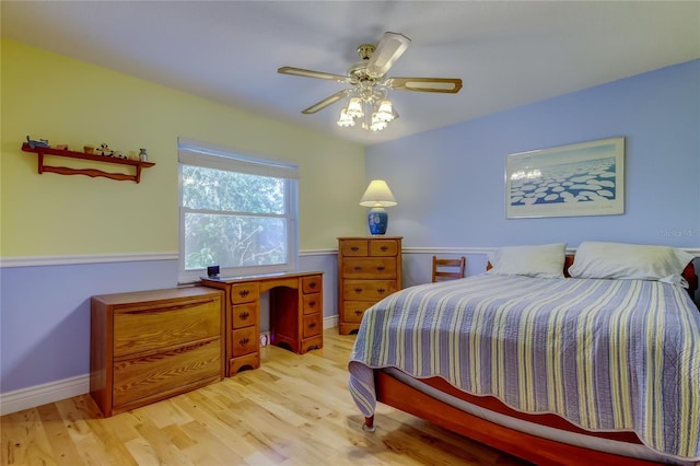 bedroom featuring ceiling fan, baseboards, and light wood-style floors