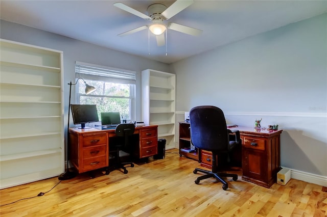 office area with a ceiling fan, baseboards, and light wood finished floors