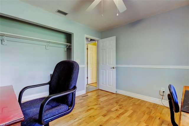 office featuring visible vents, ceiling fan, baseboards, and wood finished floors