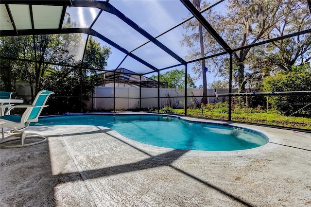 view of pool featuring a patio area, fence, glass enclosure, and a fenced in pool