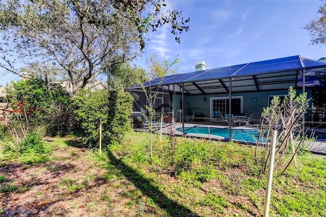 exterior space featuring a lanai and an outdoor pool