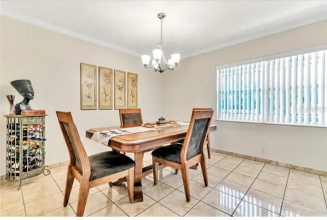 dining room featuring an inviting chandelier, light tile patterned floors, baseboards, and crown molding