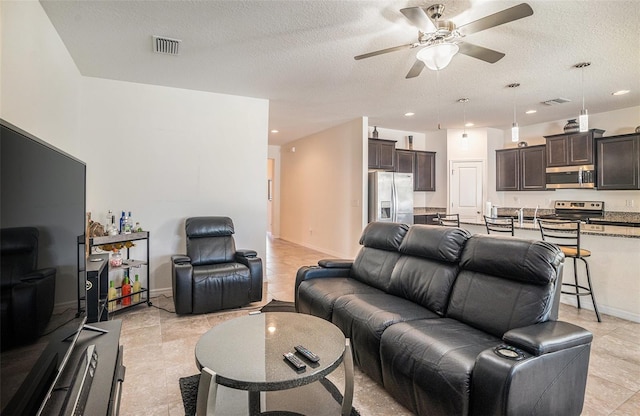 10604 Scenic Hollow Dr, Riverview, FL 33578 - living area with recessed lighting, visible vents, a ceiling fan, a textured ceiling, and baseboards