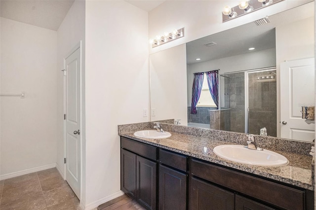 10604 Scenic Hollow Dr, Riverview, FL 33578 - bathroom featuring double vanity, a stall shower, a sink, and baseboards