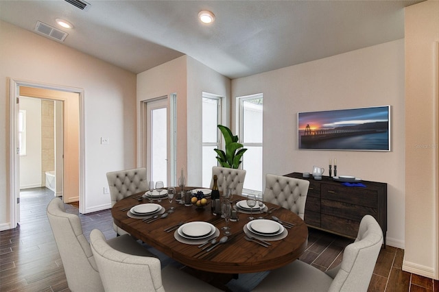 dining space with wood finish floors, lofted ceiling, recessed lighting, visible vents, and baseboards