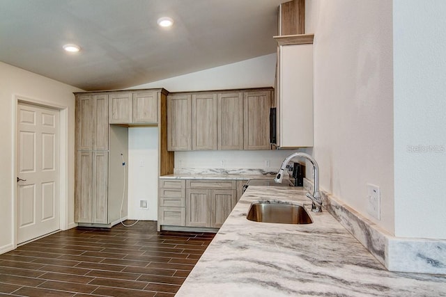 kitchen with wood finish floors, lofted ceiling, recessed lighting, light brown cabinets, and a sink