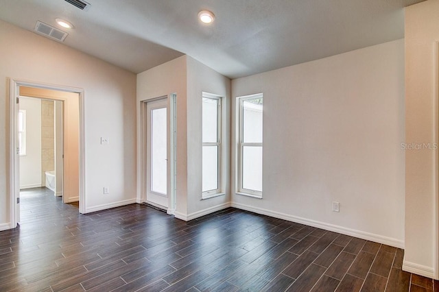 unfurnished room featuring baseboards, visible vents, dark wood-type flooring, and recessed lighting