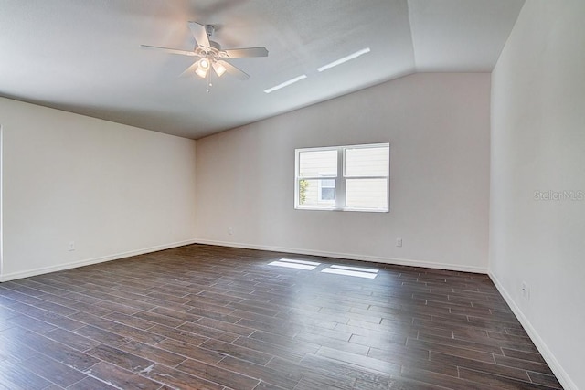 spare room featuring lofted ceiling, ceiling fan, baseboards, and dark wood-type flooring