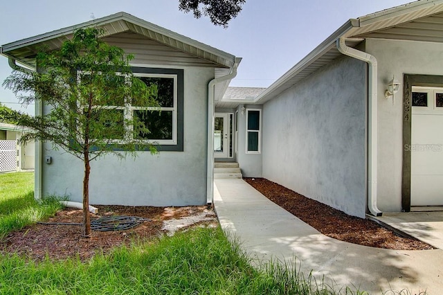 doorway to property with stucco siding