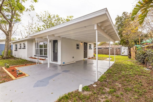 view of patio with fence and a carport