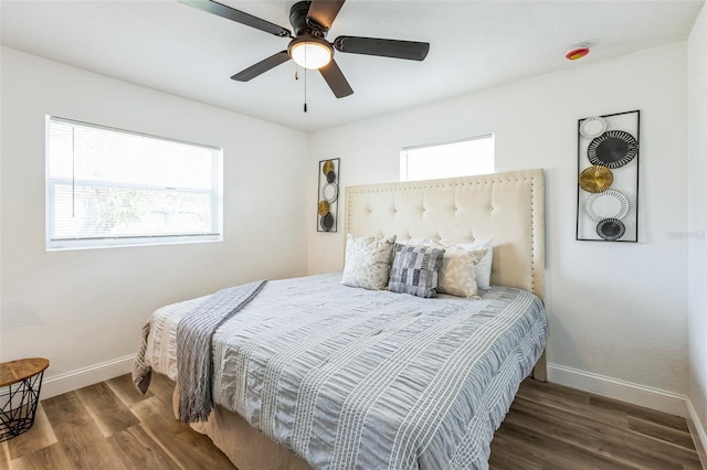 bedroom featuring ceiling fan, dark wood finished floors, and baseboards