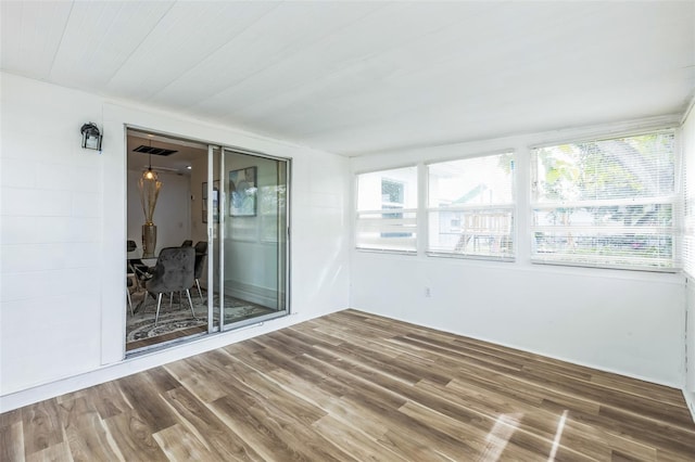 unfurnished sunroom featuring visible vents