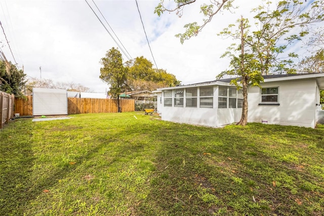 view of yard with a sunroom and a fenced backyard