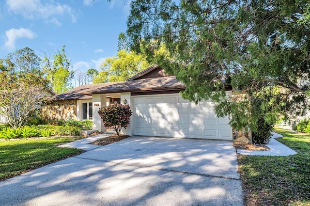 ranch-style house with stucco siding, an attached garage, and concrete driveway