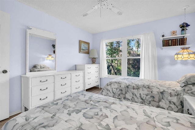 bedroom featuring a ceiling fan and a textured ceiling