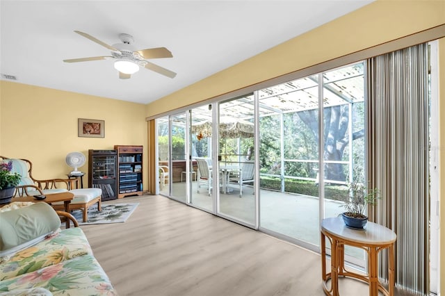 living room featuring a ceiling fan and wood finished floors